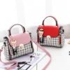 Pink and red women’s handbags with checkered panels