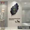 3D black leaf-shaped wooden wall clock with gold hands and modern decorative design.