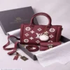 Maroon printed women’s handbag with double handles, adjustable shoulder strap,
