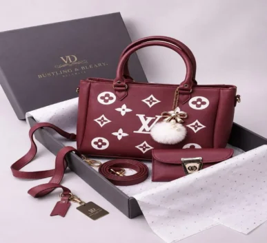 Maroon printed women’s handbag with double handles, adjustable shoulder strap,