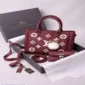 Maroon printed women’s handbag with double handles, adjustable shoulder strap,