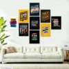 Motivational wall art posters with inspirational quotes displayed above a modern sofa