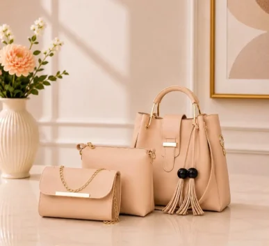 Elegant peach women’s handbag set with matching clutch and pouch.