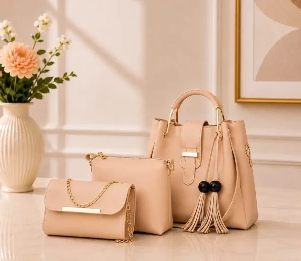 Elegant peach women’s handbag set with matching clutch and pouch.