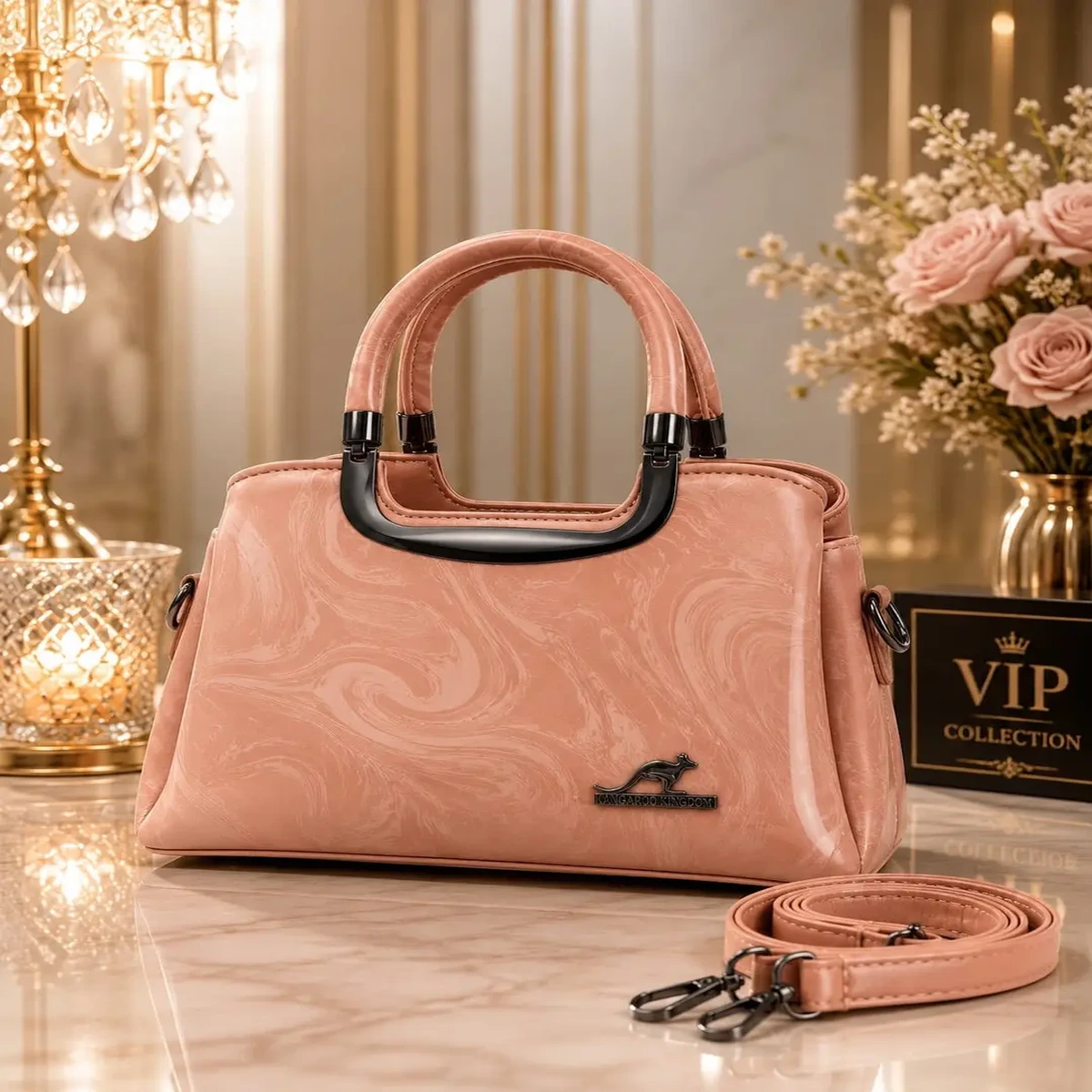 Elegant pink women’s handbag with dual handles, textured finish, and adjustable shoulder strap.