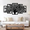 Black tree of life wall art in five-panel design above a white sofa