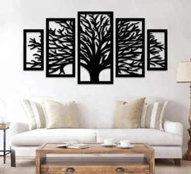 Black tree of life wall art in five-panel design above a white sofa