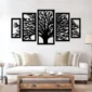 Black tree of life wall art in five-panel design above a white sofa