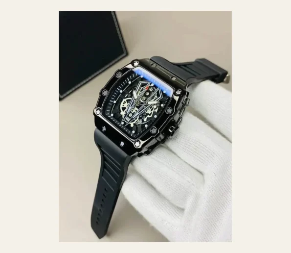 Black luxury skeleton watch with a detailed mechanical dial, rubber strap, and white glove against a beige background.